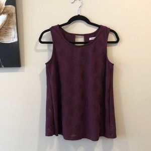 Ricki’s dark purple sleeveless blouse.